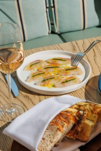 Sea bass carpaccio with citrus zest and herb oil served at Azzurra Chelsea, showcasing refined Italian seafood dining in Chelsea, London.