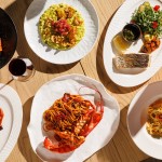 A selection of signature dishes at Azzurra Chelsea including lobster spaghetti, seafood pasta, grilled fish, risotto and traditional Italian cuisine in Chelsea, London.
