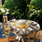 Oyster platter on ice paired with sparkling wine at Azzurra Chelsea’s outdoor terrace, offering premium seafood dining in Chelsea, London.